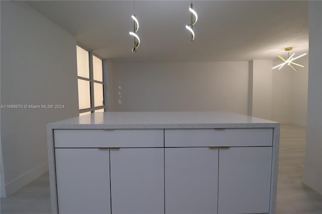 210 172nd St Unit 332, Sunny Isles Beach, FL 33160 - kitchen featuring white cabinets, light countertops, light wood-style flooring, and modern cabinets