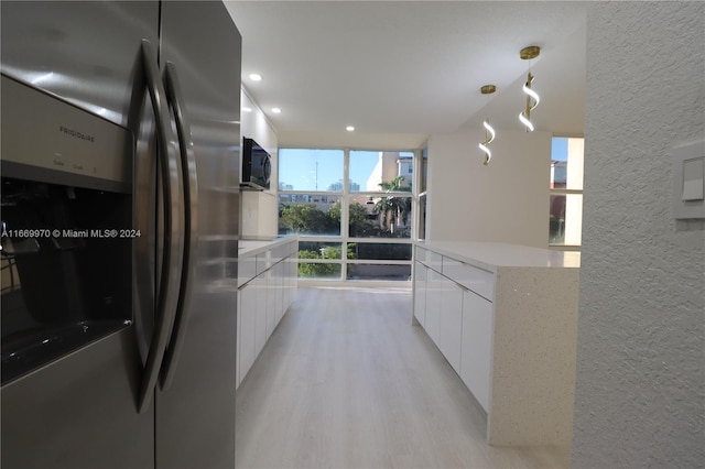 210 172nd St Unit 332, Sunny Isles Beach, FL 33160 - kitchen with stainless steel fridge, modern cabinets, white cabinetry, a textured wall, and recessed lighting