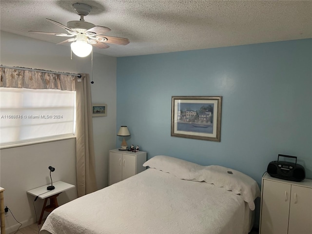 bedroom featuring a textured ceiling and ceiling fan