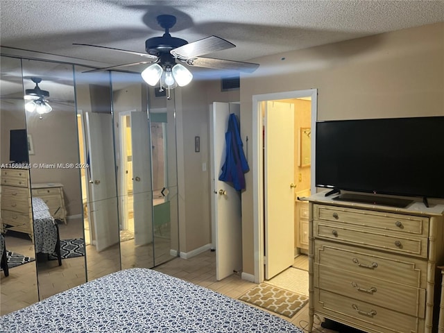 bedroom featuring a closet, a textured ceiling, ceiling fan, ensuite bathroom, and light hardwood / wood-style flooring