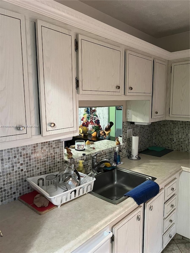 kitchen featuring sink and decorative backsplash