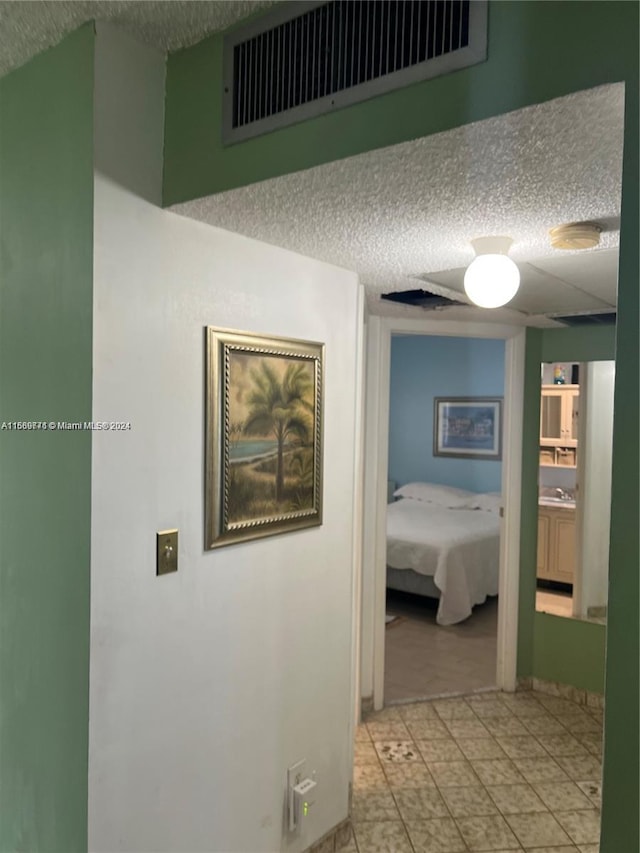 corridor with a textured ceiling