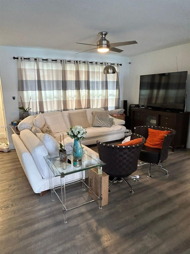 living room with ceiling fan and dark hardwood / wood-style floors