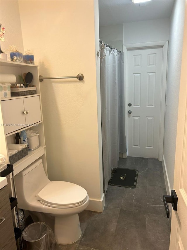 bathroom with walk in shower, vanity, and toilet