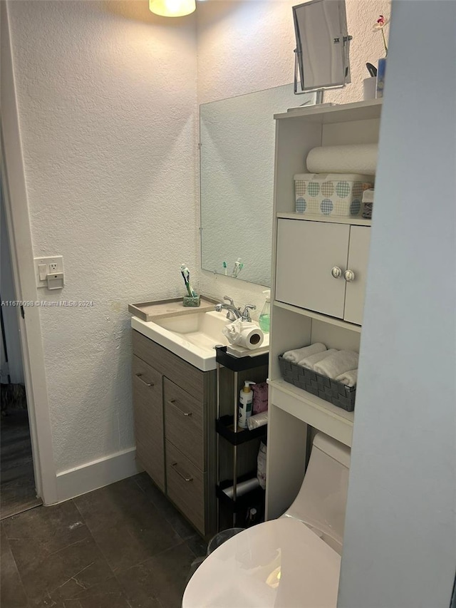 bathroom featuring vanity and toilet