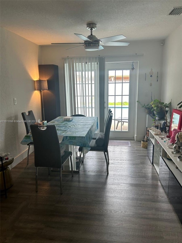 dining room featuring a textured ceiling, dark hardwood / wood-style floors, and ceiling fan