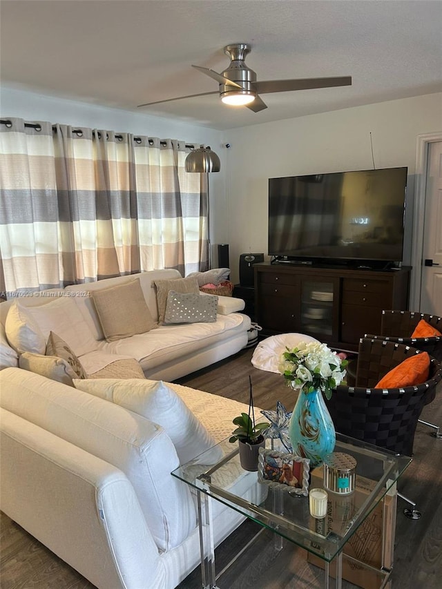 living room featuring dark hardwood / wood-style flooring and ceiling fan