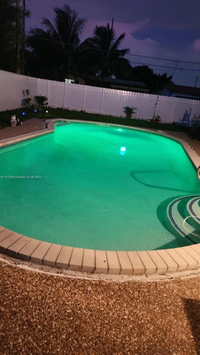 view of pool at dusk