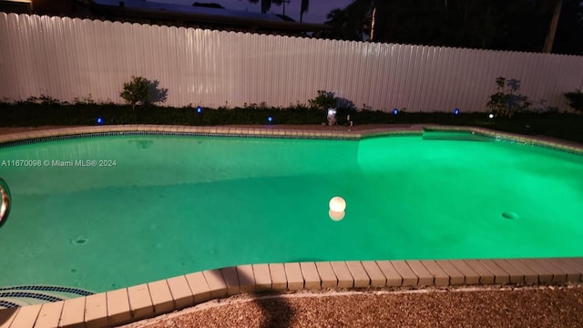 view of pool at night