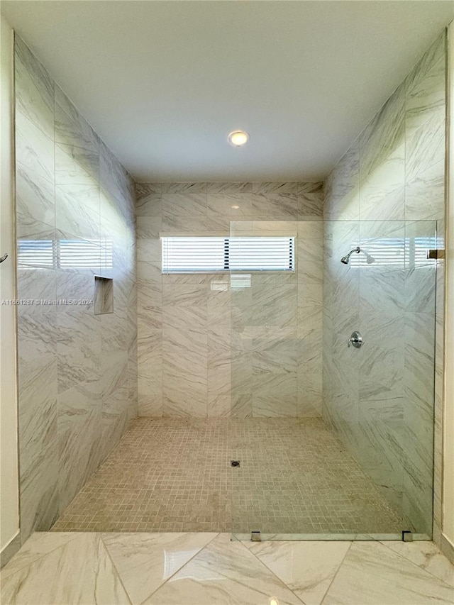 bathroom with a tile shower