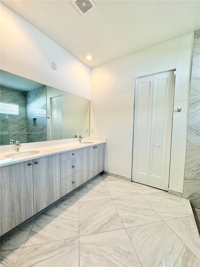 bathroom featuring a shower and vanity