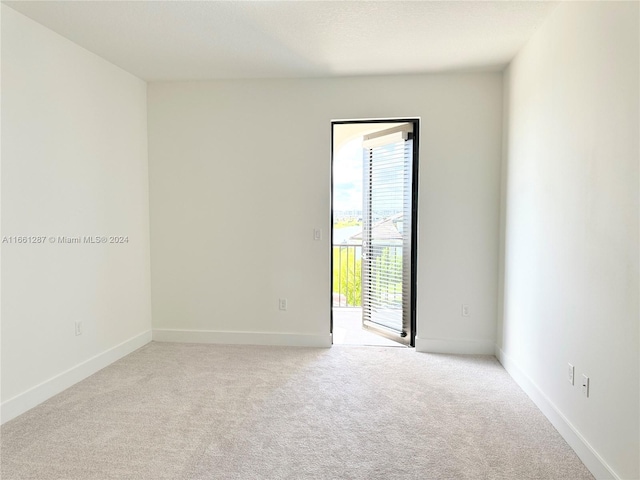 empty room featuring light colored carpet