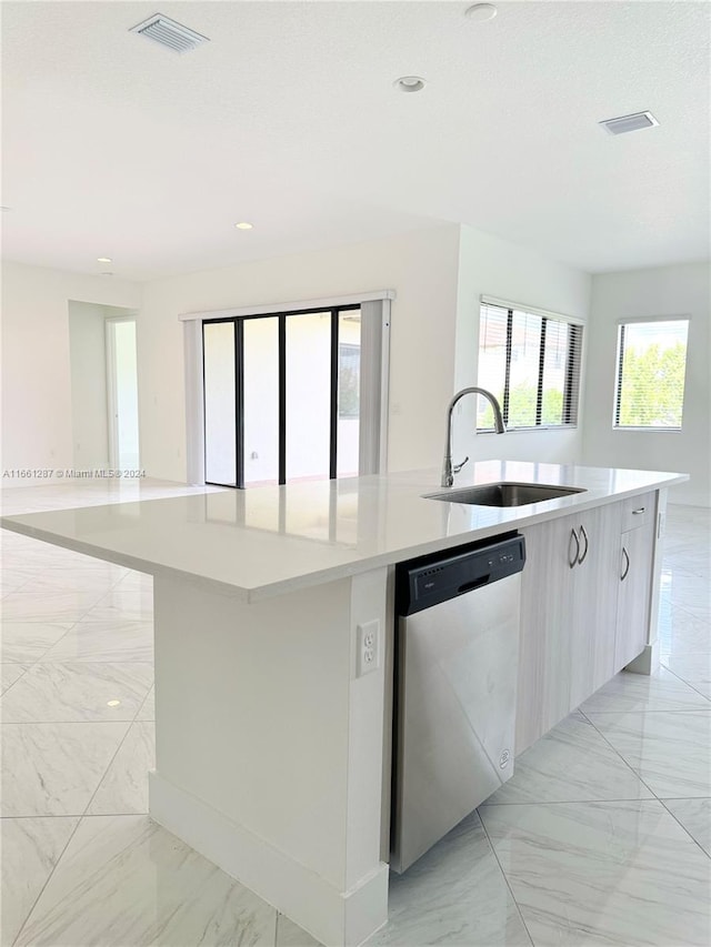 kitchen with dishwasher, a large island with sink, and sink