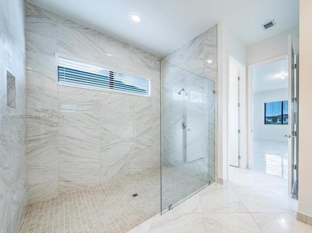 bathroom featuring tiled shower