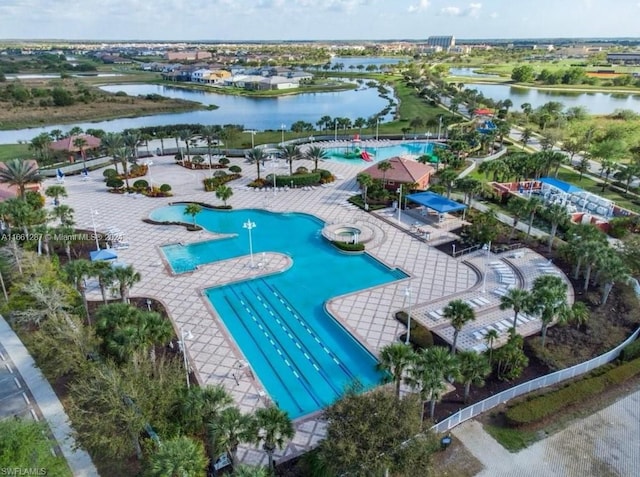 view of swimming pool featuring a patio and a water view