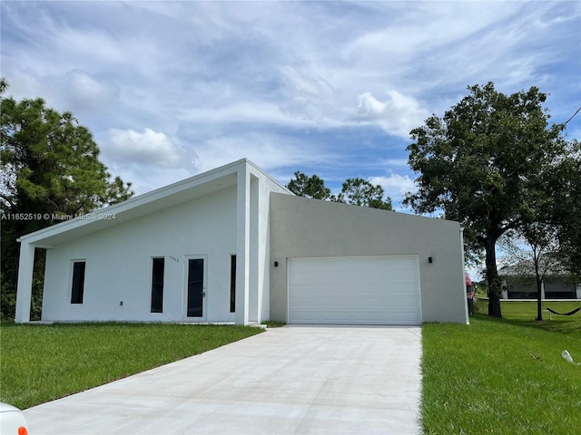 view of front of house with a garage and a front lawn