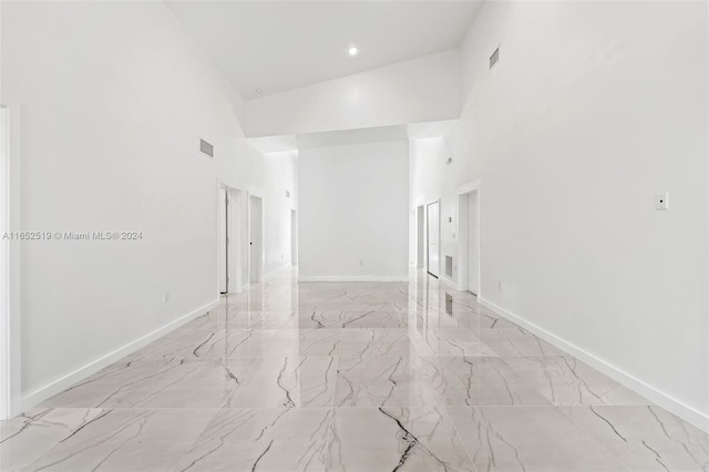 spare room featuring high vaulted ceiling