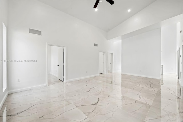 empty room featuring ceiling fan and high vaulted ceiling