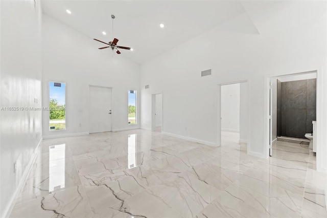 empty room featuring ceiling fan and high vaulted ceiling