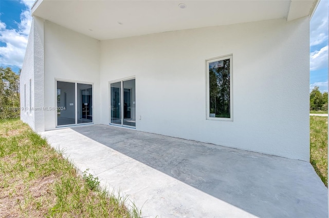 rear view of property featuring a patio area