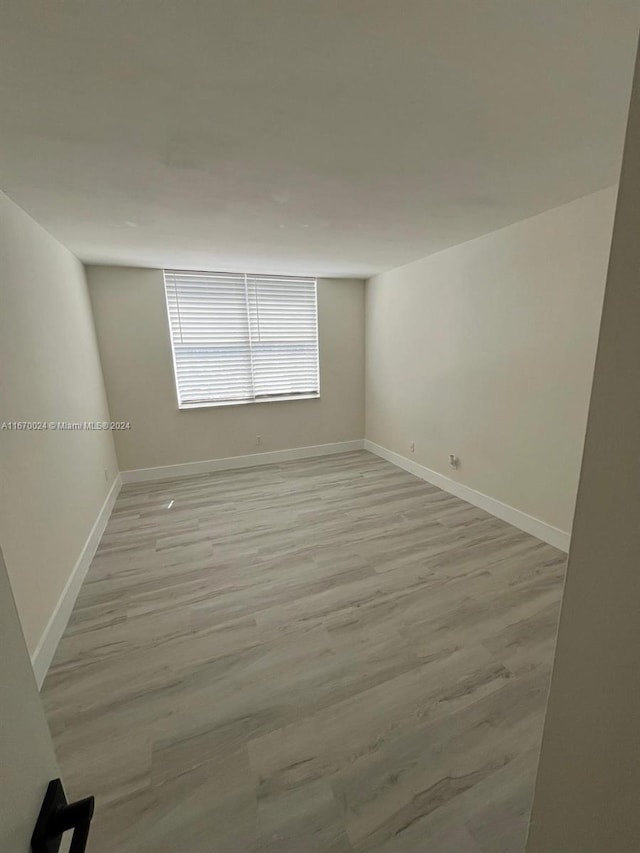 spare room featuring light hardwood / wood-style floors