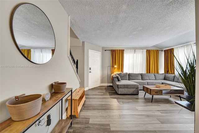 living room with hardwood / wood-style flooring and a textured ceiling