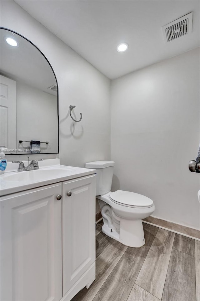 bathroom featuring hardwood / wood-style floors, vanity, and toilet