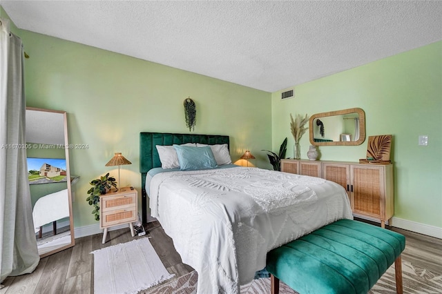 3660 SW 59th Ave Unit 1, Davie, FL 33314 - bedroom featuring baseboards, wood finished floors, visible vents, and a textured ceiling