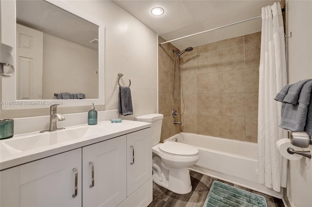 full bathroom featuring shower / tub combo with curtain, hardwood / wood-style flooring, vanity, and toilet