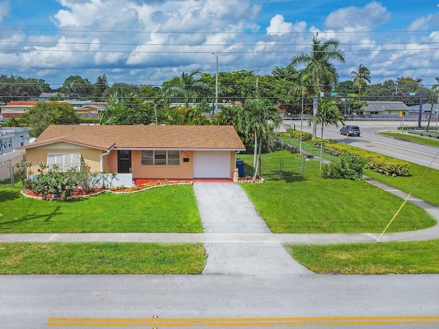 view of front of property featuring a garage and a front lawn