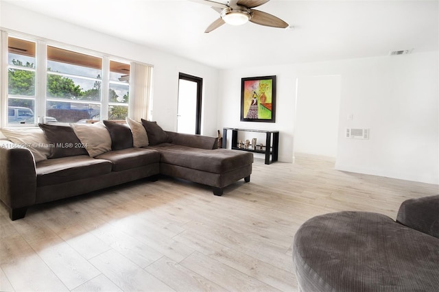 living room with light wood-type flooring and ceiling fan