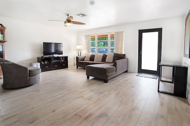 living room with ceiling fan and light wood-type flooring