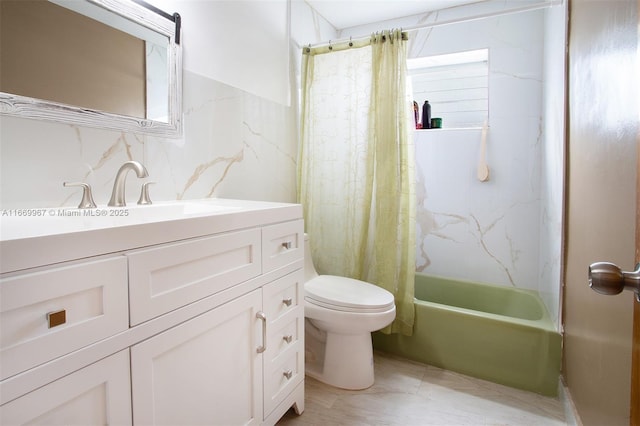 full bathroom with vanity, tile walls, toilet, and shower / tub combo with curtain