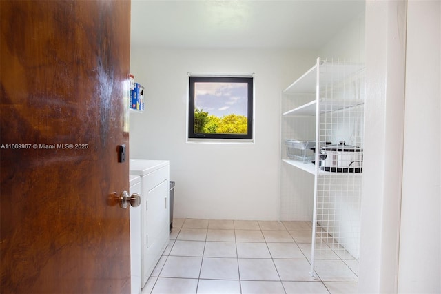 bathroom featuring tile patterned flooring, vanity, and separate washer and dryer