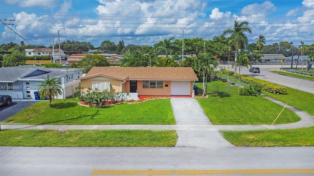 view of front of property featuring a garage and a front yard