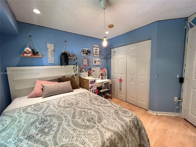 bedroom featuring wood-type flooring, a textured ceiling, and a closet