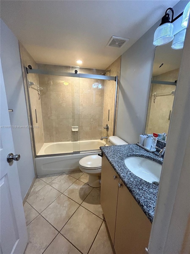 full bathroom featuring tile patterned floors, vanity, toilet, and tiled shower / bath