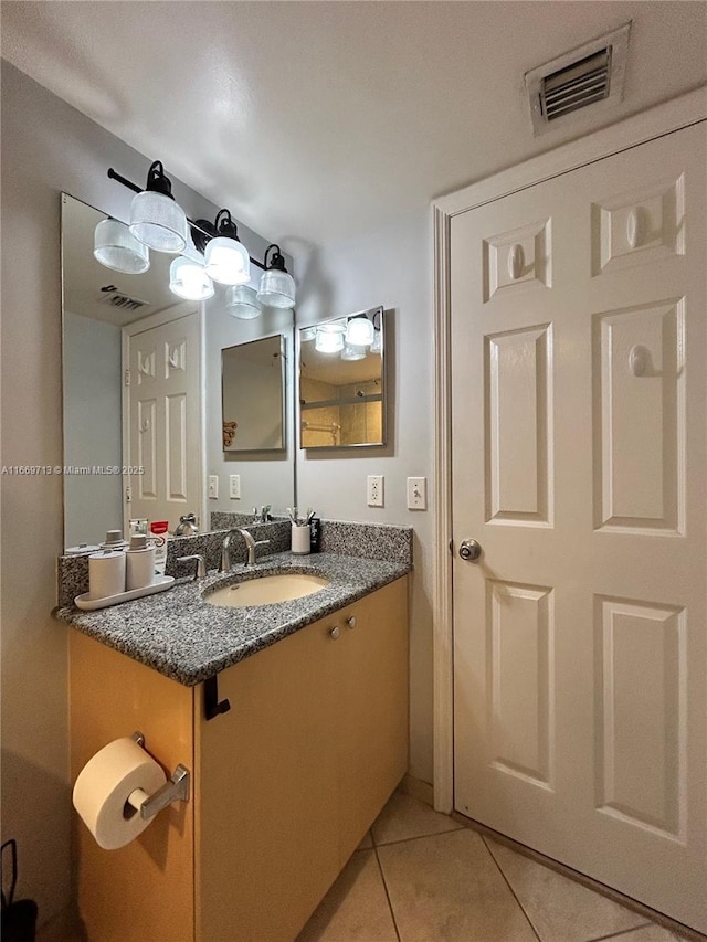 bathroom with tile patterned flooring and vanity