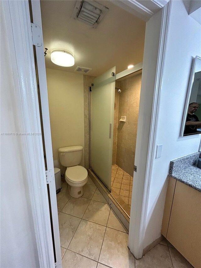 bathroom featuring tile patterned floors and a shower with shower door