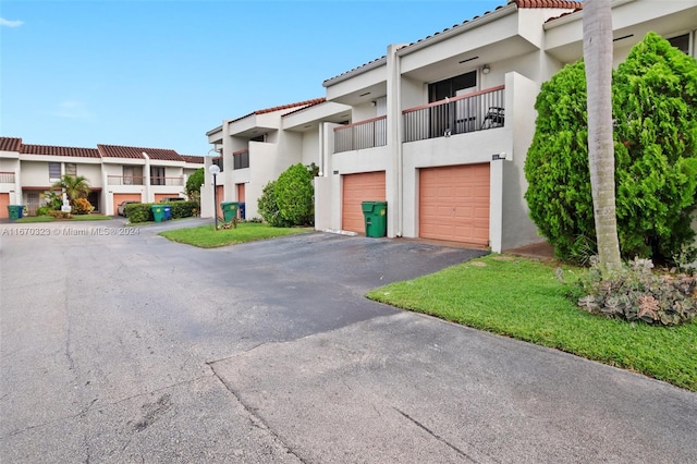 view of front of house featuring a garage and a balcony