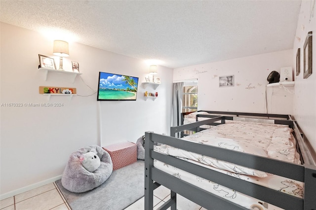 bedroom featuring a textured ceiling and light tile patterned floors