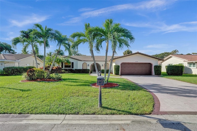 view of front of property with a garage and a front yard