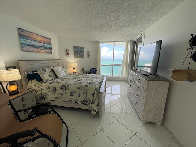 bedroom with a textured ceiling and light tile patterned floors