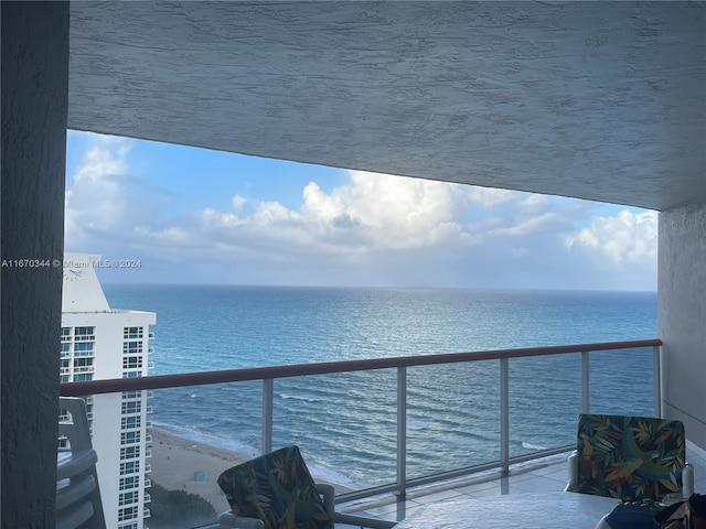 balcony with a view of the beach and a water view