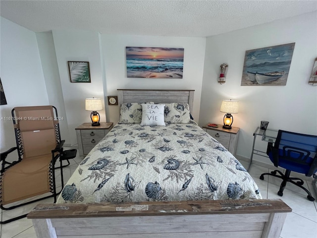 tiled bedroom featuring a textured ceiling