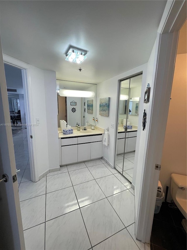 bathroom with tile patterned floors, vanity, and toilet