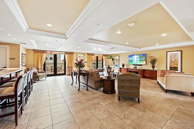 living room with french doors, a raised ceiling, and ornamental molding