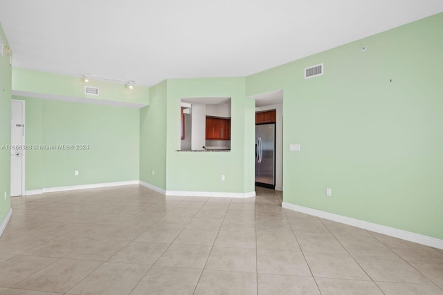 spare room featuring light tile patterned floors