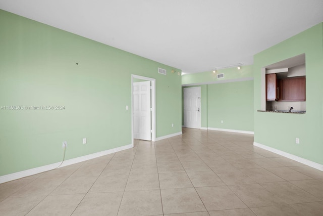 tiled empty room with track lighting