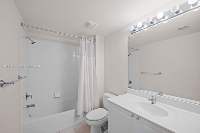 full bathroom featuring shower / tub combo with curtain, tile patterned flooring, vanity, and toilet